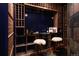 Modern wine cellar with wood racking, seating, and dark walls at 1070 Cypress Way, Castle Rock, CO 80108