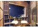 Unique wine cellar with dark blue walls, custom shelving, and seating at 1070 Cypress Way, Castle Rock, CO 80108