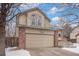 Charming two-story home with a brick-accented facade, a two-car garage, and well-maintained landscaping at 742 Cameron Ln, Longmont, CO 80504