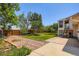 A spacious backyard with a patio and mature trees and fence line provides privacy and room for outdoor enjoyment at 2603 W 100Th Pl, Denver, CO 80260