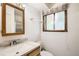 Bright bathroom featuring a wood-framed mirror and vanity plus a shower with framed sliding doors at 2603 W 100Th Pl, Denver, CO 80260