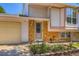 Inviting front entrance with a brick facade and beautiful garden, enhancing the home's curb appeal at 2603 W 100Th Pl, Denver, CO 80260