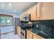 Modern kitchen with stainless steel appliances, green marble counters, and bright, natural light at 2603 W 100Th Pl, Denver, CO 80260