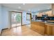 Open kitchen with wooden cabinets, granite countertops, stainless appliances, and a sunroom off the side at 2603 W 100Th Pl, Denver, CO 80260