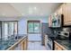 Bright kitchen featuring a stainless steel fridge, tile floors, and lots of counter space at 2603 W 100Th Pl, Denver, CO 80260