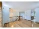 Spacious living area with hardwood floors, showcasing the staircase and a view into the kitchen at 2603 W 100Th Pl, Denver, CO 80260
