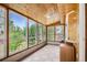The sunny sunroom boasts many windows for natural light and a scenic view of the outdoors at 2603 W 100Th Pl, Denver, CO 80260
