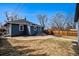 Expansive backyard with manicured lawn and patio, ideal for outdoor activities at 5094 Meade St, Denver, CO 80221