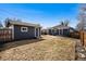 View of detached garage and fenced backyard offering privacy and security at 5094 Meade St, Denver, CO 80221