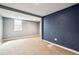 Basement area with new carpet, window and dark accent wall at 5094 Meade St, Denver, CO 80221