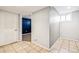 Finished basement area with tile floor, window, and door to adjacent room at 5094 Meade St, Denver, CO 80221