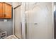 Closeup of tiled shower with decorative frosted glass door in bathroom at 5094 Meade St, Denver, CO 80221