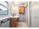 Bathroom with double sink vanity, oak cabinets, and tiled shower at 5094 Meade St, Denver, CO 80221