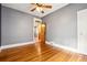 Bright bedroom featuring hardwood floors, neutral walls, and decorative glass doorway at 5094 Meade St, Denver, CO 80221