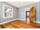 Cozy bedroom features hardwood floors, neutral walls and a doorway to another room at 5094 Meade St, Denver, CO 80221