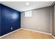 Bedroom featuring new carpet, dark accent wall and new window at 5094 Meade St, Denver, CO 80221