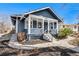 Inviting front porch showcasing the home's exterior and charming features on a sunny day at 5094 Meade St, Denver, CO 80221