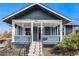 Inviting front porch showcasing the home's blue exterior, white trim, and charming curb appeal at 5094 Meade St, Denver, CO 80221