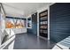 Inviting front porch showcasing the home's blue exterior, white trim, and transom window above the door at 5094 Meade St, Denver, CO 80221