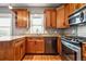 Charming kitchen featuring wood cabinets, granite countertops, stainless steel appliances, and a window for natural light at 5094 Meade St, Denver, CO 80221