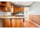 Kitchen featuring stainless steel appliances, granite countertops, and wood cabinetry at 5094 Meade St, Denver, CO 80221