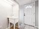 Bright laundry room features a utility sink with faucet and white door with tiled floors at 5094 Meade St, Denver, CO 80221