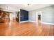 Spacious living room featuring wood floors, modern lighting and a doorway leading to a room with shelving at 5094 Meade St, Denver, CO 80221