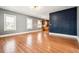 Spacious living room featuring hardwood floors, bright windows, and an open layout to the kitchen at 5094 Meade St, Denver, CO 80221