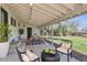 Comfortable back porch boasts an outdoor dining table and relaxing lounge area at 130 S Eaton St, Lakewood, CO 80226
