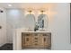 Bright bathroom boasts double vanity, marble floors and shower, and gold fixtures at 130 S Eaton St, Lakewood, CO 80226