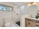 This bathroom features a modern vanity, shower with marble tiling, and black honeycomb floor at 130 S Eaton St, Lakewood, CO 80226