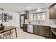 Bright kitchen showcasing stainless steel appliances, sleek countertops, and wood cabinets, offering an efficient cooking area at 130 S Eaton St, Lakewood, CO 80226