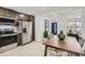 Open-concept kitchen featuring stainless steel appliances, modern cabinetry, and an adjacent dining area creating a cozy space at 130 S Eaton St, Lakewood, CO 80226