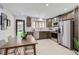 Modern kitchen with stainless steel appliances, wooden cabinets, and a view to the backyard, perfect for Gathering meals at 130 S Eaton St, Lakewood, CO 80226