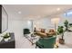 Finished basement living room with brown leather sofa and green velvet chairs at 130 S Eaton St, Lakewood, CO 80226