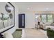 Inviting living room featuring ample natural light, light wood floors, and contemporary decor with a view of the outdoors at 130 S Eaton St, Lakewood, CO 80226