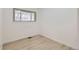 A bright empty room with light hardwood flooring and window provides a blank slate at 130 S Eaton St, Lakewood, CO 80226