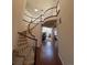 Grand foyer with hardwood floors, curved staircase and a view of the living room at 14241 Ivanhoe St, Thornton, CO 80602