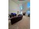 Bright living room featuring high ceilings, large windows, modern light fixture and a fireplace at 14241 Ivanhoe St, Thornton, CO 80602