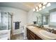 Bathroom featuring double sinks, updated fixtures, and a separate shower stall at 1563 Bellflower Dr, Brighton, CO 80601