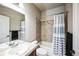 Well-lit bathroom featuring a vanity sink, mirror, and a shower-tub combination at 1563 Bellflower Dr, Brighton, CO 80601