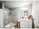 Bathroom featuring a glass-enclosed shower and a vanity with storage at 1563 Bellflower Dr, Brighton, CO 80601