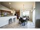 Inviting dining area with a chandelier, table, and access to the outdoor patio at 1563 Bellflower Dr, Brighton, CO 80601