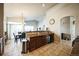 Spacious kitchen featuring a central sink, ample counter space, and modern appliances at 1563 Bellflower Dr, Brighton, CO 80601