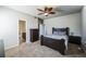 Comfortable bedroom with a ceiling fan, dresser, and ensuite bathroom access at 1563 Bellflower Dr, Brighton, CO 80601