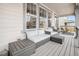 Relax in comfort on this back porch with outdoor couches, chairs, and views of the yard at 2598 Knobbie Cir, Castle Rock, CO 80109