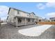 Spacious backyard with covered porch, rock landscaping, and winter lawn for relaxation and outdoor enjoyment at 2598 Knobbie Cir, Castle Rock, CO 80109