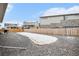 Expansive backyard featuring gravel landscaping and wood fence, offering privacy and space for recreation at 2598 Knobbie Cir, Castle Rock, CO 80109