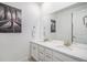 Bright bathroom features a double sink vanity with quartz countertop and modern fixtures at 2598 Knobbie Cir, Castle Rock, CO 80109