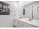 Bright bathroom featuring a double sink vanity with white cabinets and a large mirror at 2598 Knobbie Cir, Castle Rock, CO 80109